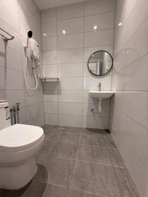 a bathroom with a toilet and a sink at Taman Bagan Homestay in Butterworth