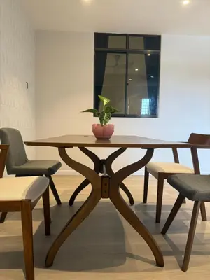 a wooden table with a potted plant sitting on top at Taman Bagan Homestay in Butterworth