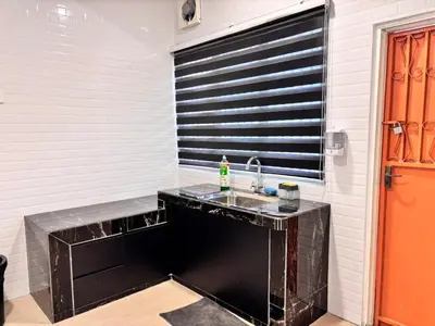 a bathroom with a sink and a black and white wall at The Crayon Shin-chan Themed Stay Family Ipoh By LUX SUITE in Ipoh