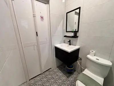 a bathroom with a toilet and a sink and a shower at The Crayon Shin-chan Themed Stay Family Ipoh By LUX SUITE in Ipoh