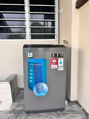 a machine sitting in front of a window at The Crayon Shin-chan Themed Stay Family Ipoh By LUX SUITE in Ipoh