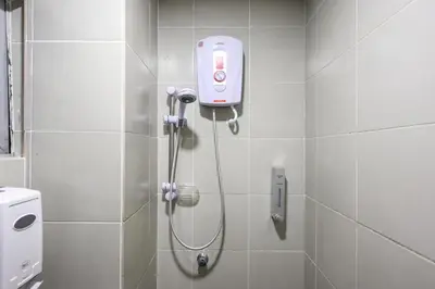 a bathroom with a shower with a camera on the wall at Emerald Avenue Brinchang Near Centrum- Cozy Family Stay Clover Home 5-06 in Brinchang