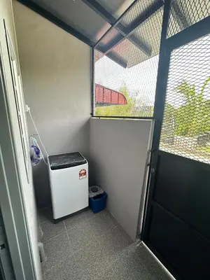 a small room with a small refrigerator and a window at RJ Homestay Bandar Utama Gua Musang in Gua Musang