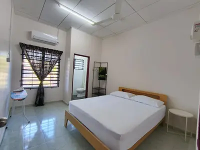 a bedroom with a white bed and a window at Nariz Homestay Kuala Ketil in Kuala Ketil