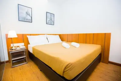 a bedroom with a large bed with two pillows on it at Urban Inn Kulim in Kulim