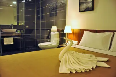 a swan made out of towels on a bed at Urban Inn Kulim in Kulim