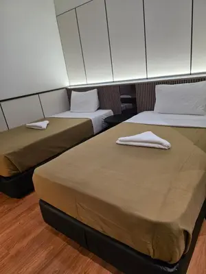 two beds in a room with two mattresses at Urban Inn Kulim in Kulim