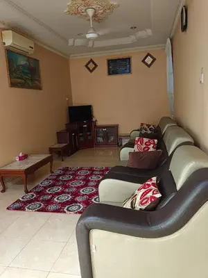 a living room with a couch and a table at Homestay Bedong Teratak Kasih in Gua Sai