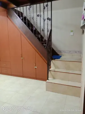a staircase in a room with some stairs gmaxwell gmaxwell gmaxwell at Homestay Bedong Teratak Kasih in Gua Sai