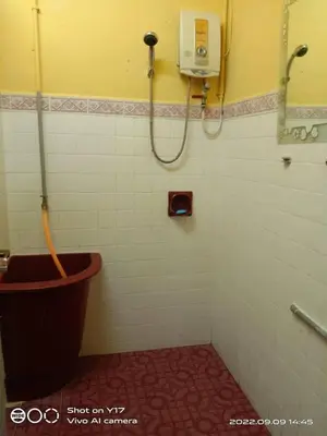 a bathroom with a shower with a toilet in it at Homestay Bedong Teratak Kasih in Gua Sai