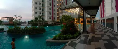 a person walking in a swimming pool in a building at Nilai Mesahill Premier Deluxe Luxury Homestay,Mesamall in Gua Sai
