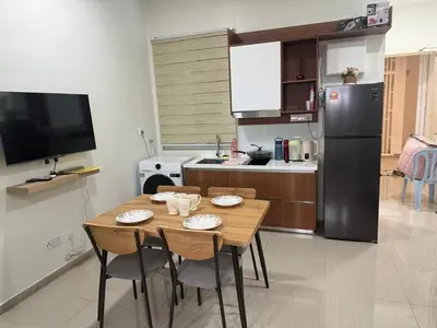 a kitchen with a table with chairs and a refrigerator at Nilai Mesahill Premier Deluxe Luxury Homestay,Mesamall in Gua Sai