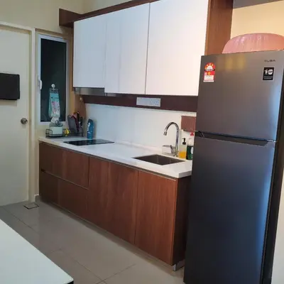 a kitchen with a stainless steel refrigerator and wooden cabinets at Nilai Mesahill Premier Deluxe Luxury Homestay,Mesamall in Gua Sai