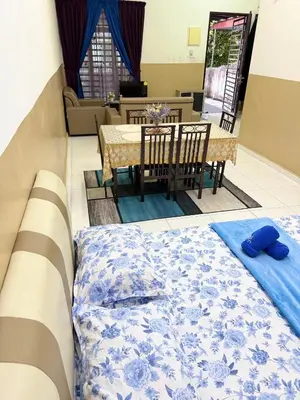 a room with a bed and a table and a dining room at Seri Pinggiran HOMESTAY Bertam Perdana in Kepala Batas