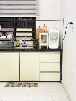 a kitchen with white cabinets and a white microwave at Seri Pinggiran HOMESTAY Bertam Perdana in Kepala Batas