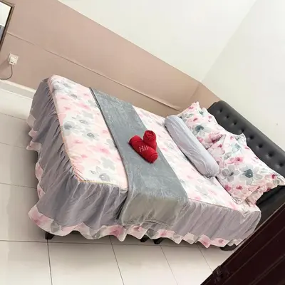 a bed with two red hearts sitting on it at Seri Pinggiran HOMESTAY Bertam Perdana in Kepala Batas