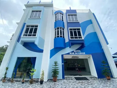 a blue and white building with a hotel malaysia at Mak Sa'adiah Hotel in Kampung Teluk Nipah