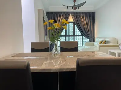 a vase of yellow flowers sitting on a table at NEW Bt Kawan8 3BR Suite-IKEA-UOW-KDU-ColumbiaAsia in Simpang Ampat