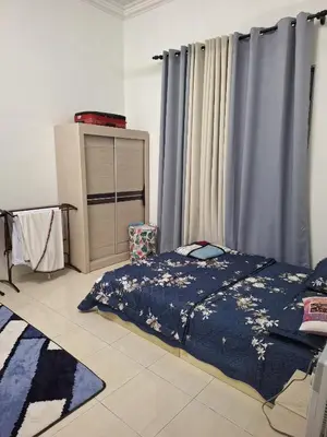 a bedroom with a bed and a dresser and curtains at Rosselle Homestay, Sabak Bernam in Sabak Bernam