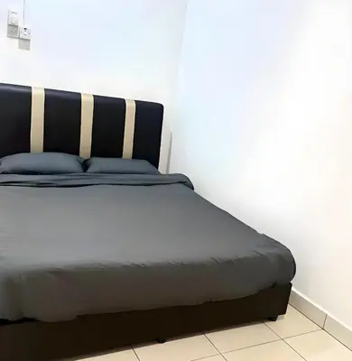 a bed in a corner of a room at J Cozy Stay - 3B 2B, Fair Park Ipoh in Ipoh