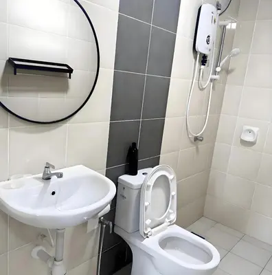 a bathroom with a sink and a toilet and a mirror at J Cozy Stay - 3B 2B, Fair Park Ipoh in Ipoh