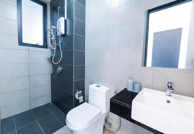 a bathroom with a toilet and a sink and a mirror at Urban Suites Jelutong Georgetown Penang 6pax 3BR Family Cozy Homestay in George Town