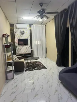 a living room with a couch and a tv at laman terrace in Sungai Petani
