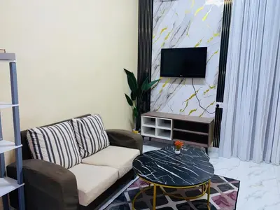 a living room with a couch and a tv at laman terrace in Sungai Petani