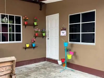 a room with potted plants on the corner of a house at Homestay ABAH in Nibung Tebal