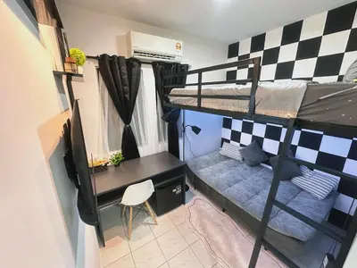 a dorm room with a desk and bunk beds at Unisuites Kampar Studio UTAR TARC -3pax, Pet Friendly, FREE 1 Carpark & Netflix in Kampar