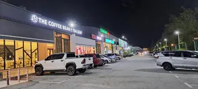 a parking lot with cars parked in front of a store at Unisuites Kampar Studio UTAR TARC -3pax, Pet Friendly, FREE 1 Carpark & Netflix in Kampar