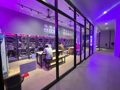 a group of people sitting in a laundry room at Unisuites Kampar Studio UTAR TARC -3pax, Pet Friendly, FREE 1 Carpark & Netflix in Kampar