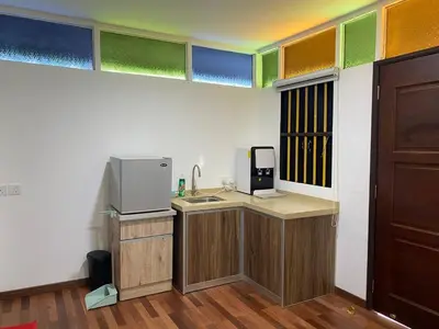a room with a kitchen with a sink and a microwave at Rumah Inap Kampung Agong Sunrise in Penaga
