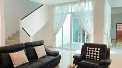 a living room with a couch and a chair at Alle House by Wei in Kampong Gurun