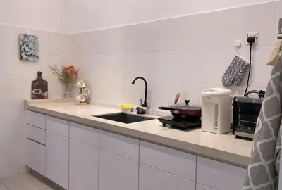 a kitchen with a sink and a counter top at Alle House by Wei in Kampong Gurun