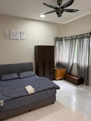 a bedroom with a bed and a ceiling fan at Ayaan Quintet Evergreen with FIFA & Private Parking in Tanah Rata