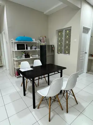 a dining room with a black table and white chairs at Ayaan Quintet Evergreen with FIFA & Private Parking in Tanah Rata