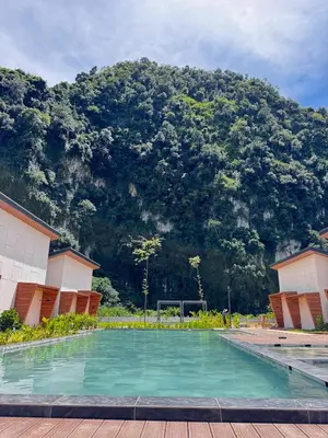 a swimming pool with a mountain in the background at Tambuna Retreat ,TAMBUN ,IPOH in Tambun