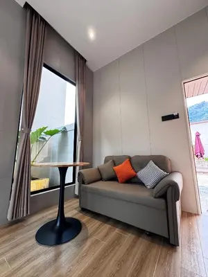 a living room with a couch and a table at Tambuna Retreat ,TAMBUN ,IPOH in Tambun