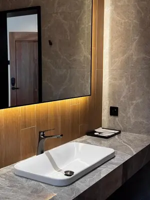 a bathroom with a white sink and a mirror at Tambuna Retreat ,TAMBUN ,IPOH in Tambun