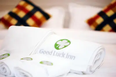 a pile of white towels sitting on top of a counter at Good Luck Inn in Ayer Itam