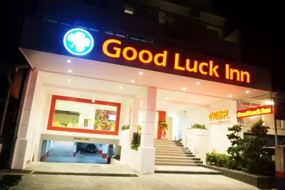 a good luck inn sign in front of a building at Good Luck Inn in Ayer Itam