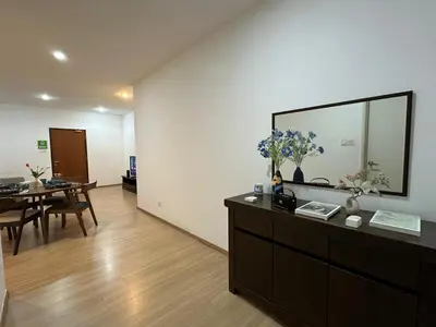 a living room with a dresser with a mirror and a table at Modern Cozy Seaview Entire Suites 118 Island Plaza in George Town