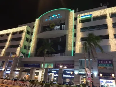 a building with a sign on the side of it at Modern Cozy Seaview Entire Suites 118 Island Plaza in George Town
