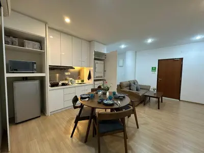 a kitchen and living room with a table and a couch at Modern Cozy Seaview Entire Suites 118 Island Plaza in George Town