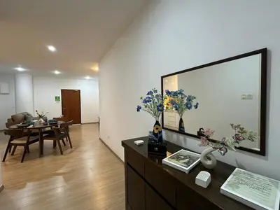 a living room with a table and a large picture on the wall at Modern Cozy Seaview Entire Suites 118 Island Plaza in George Town
