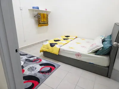 a bedroom with a bed and a floor with a rug at QaiDaff Homestay CH in Cameron Highlands