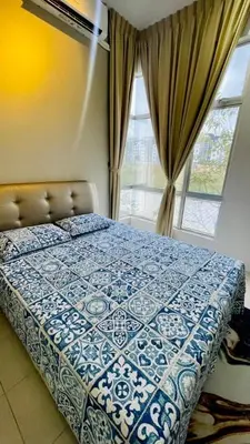 a bedroom with a blue and white bed with a window at RR Casa Space Homestay Ipoh in Ipoh