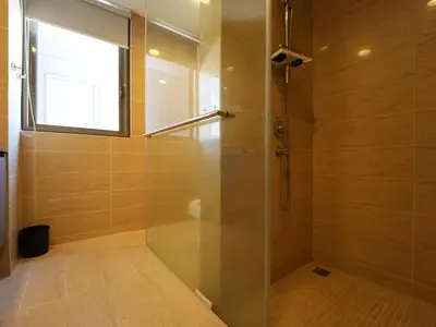 a shower with a glass door in a bathroom at Cozy Seaview Escape 2BR 6pax bythesea bathroom in Pulau Pinang