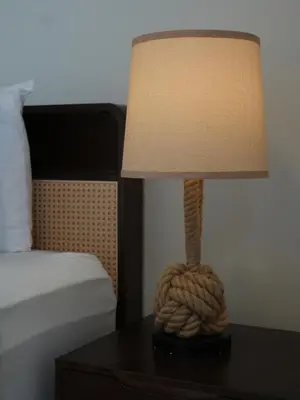 a lamp sitting on a table next to a bed at Cozy Seaview Escape 2BR 6pax bythesea bathroom in Pulau Pinang